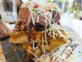 photo of a very appetizing waffle ice cream filled with cheese and chocolate toppings, usually used for regular menu covers as well as recipe book covers