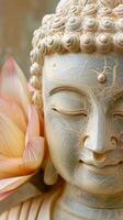 Close-up of a serene Buddha statue with a lotus blossom photo