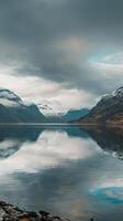 Mountain range mirrored in a still lake photo