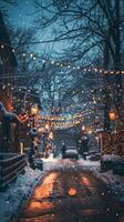 A quiet street, covered in snow, with string lights and streetlights casting a warm glow photo