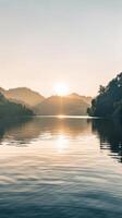 A still lake reflects the sunrise and rolling hills photo