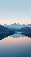 Mountain range reflecting on a still lake at dawn photo