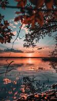 Tranquil lake at sunset with a golden glow photo