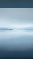 A still lake with a soft, misty fog rolling across the water photo