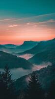 Misty mountain landscape with a soft, pink sunset sky photo