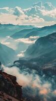 A breathtaking view of a mountain range with clouds forming a sea below photo