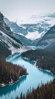 A river meanders through a snowy mountain valley photo