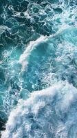 Ocean waves crashing, creating white foam on turquoise water photo