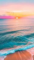 Peaceful ocean sunset with a wave crashing on a sandy beach photo