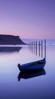 A lone boat rests on the surface of a calm lake at dusk photo