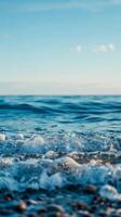 Blue water with whitecaps crashes on the shore photo