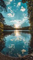 Sunset over a calm forest lake with trees reflected in the water photo