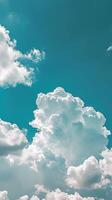 White clouds drift across a bright blue sky photo