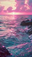 Pink sunset reflects on blue ocean waves photo