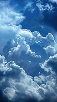 White, fluffy clouds drift across a vibrant blue sky photo