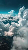 White clouds drift over mountain peaks photo