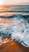 Waves breaking on a sandy beach at sunset, golden light photo