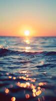 A golden sunset casts shimmering reflections on the surface of the ocean waves photo