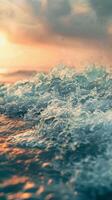 Close-up of foamy ocean waves with a golden sunset in the background photo