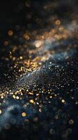 Glimmering golden dust and a blue nebulae on a black background photo