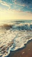 Foamy waves gently roll onto a sandy beach, lit by the warm glow of a setting sun photo
