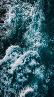 Whitecaps swirl in dark blue water photo