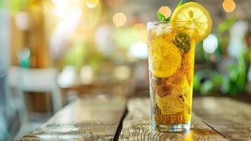 Glass of ginger ale with lemon and mint on a table photo