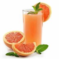 A tall glass of grapefruit juice with fresh mint garnishes and grapefruit slices photo