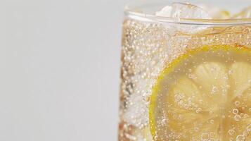 Close-up shot of a glass filled with lemon lime soda and ice, featuring a slice of lemon photo