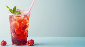 Iced tea with raspberries, mint, and ice cubes photo