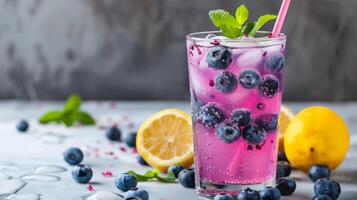 Blueberry lemonade with mint, blueberries, and lemon slices on table photo