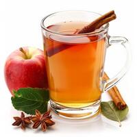 A glass mug of apple cider with a cinnamon stick, an apple, and star anise photo
