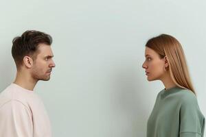 A man and a woman are facing one another and they appear to be arguing with each other photo