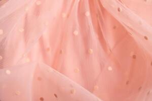 Tulle fabric texture background, textile pattern, pink polka dot on tulle, copy space photo