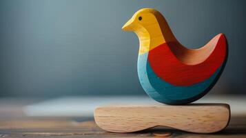 A vibrant wooden dove toy sits on a desk, ready for imaginative play photo