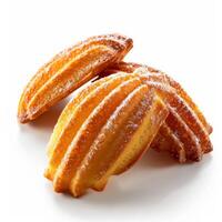 Close-up of three golden-brown madeleine pastries photo