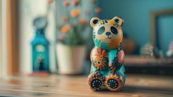 A colorful wooden panda toy sits on a desk photo