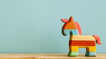 A colorful wooden horse toy sits on a desk photo