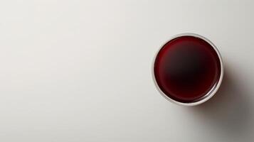 A glass of prune juice sits on a white background photo