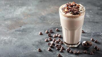 Chocolate milkshake topped with chocolate chips and whipped cream photo