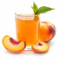 Glass of peach nectar with peach slices and a leaf photo