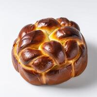 A freshly baked brioche loaf, its golden crust glistening under the studio lights photo