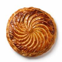 A freshly baked Pithivier pastry, its golden crust gleaming under studio lights photo