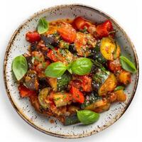 Bowl of ratatouille with eggplant, zucchini, tomatoes, and peppers photo