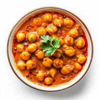 A close-up view of a bowl of chickpea curry topped with fresh parsley photo