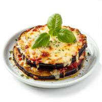 A single serving of eggplant parmesan is presented on a white plate, ready to be enjoyed photo