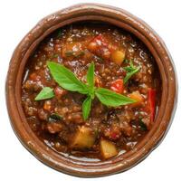 A close-up shot of vegetarian gumbo in a bowl, garnished with fresh basil leaves photo