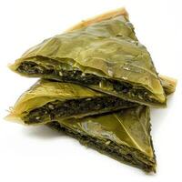 Three slices of Spanakopita, a Greek pastry filled with spinach and feta cheese photo