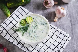 Traditional Greek tzatziki sauce in a bowl on the table photo