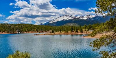 Panorama Snow-capped and forested mountains near a mountain lake, Pikes Peak Mountains in Colorado Spring, Colorado, US photo